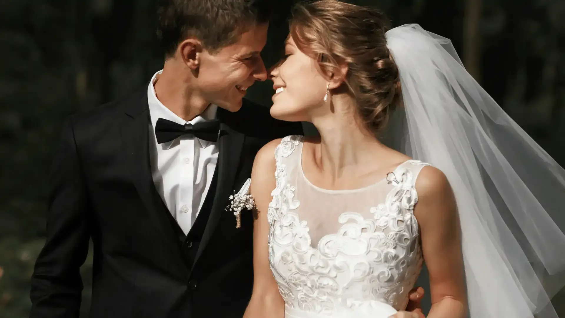 A bride and groom are kissing each other on their wedding day.