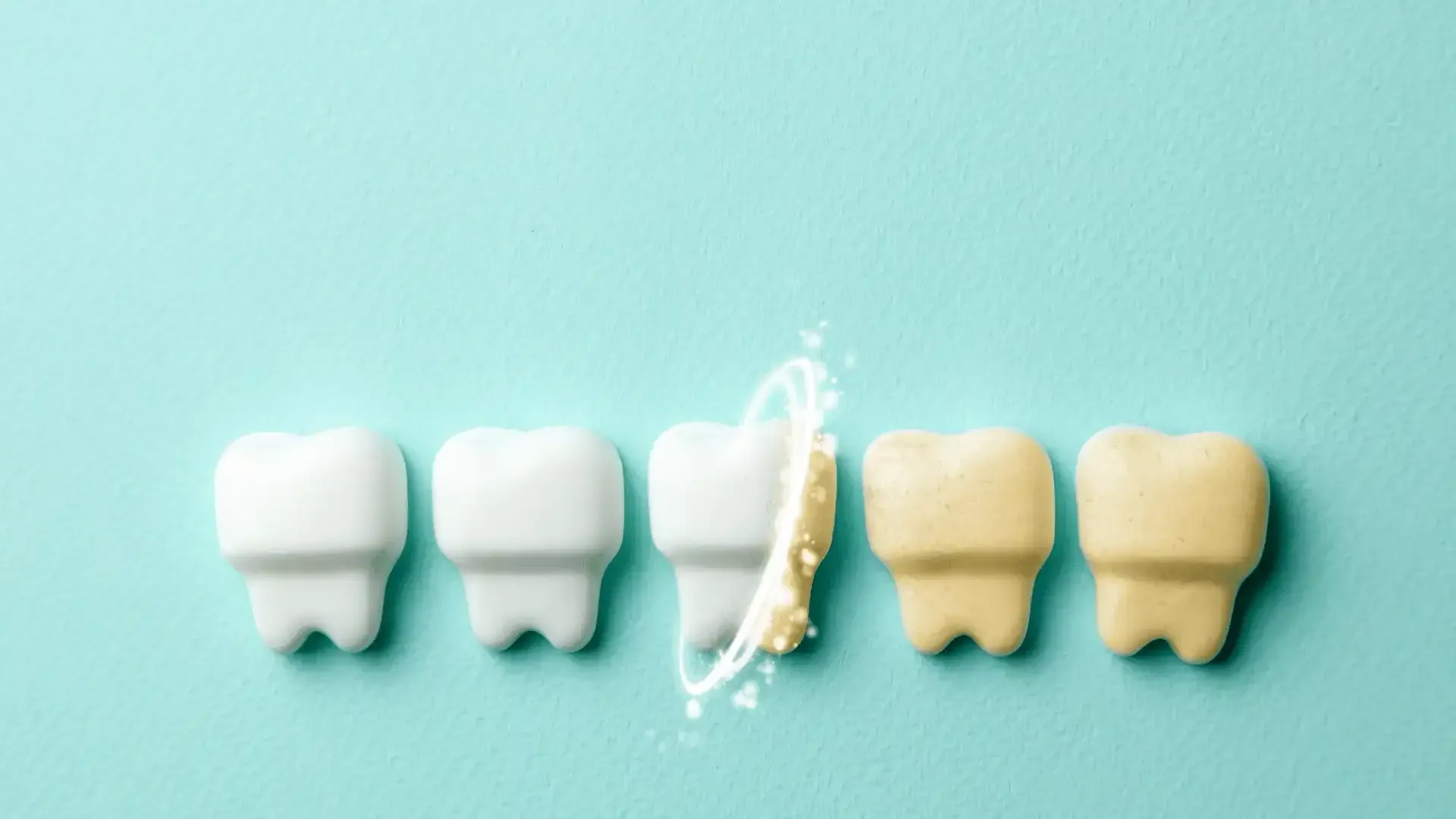 a row of white teeth next to a row of yellow teeth on a blue background .