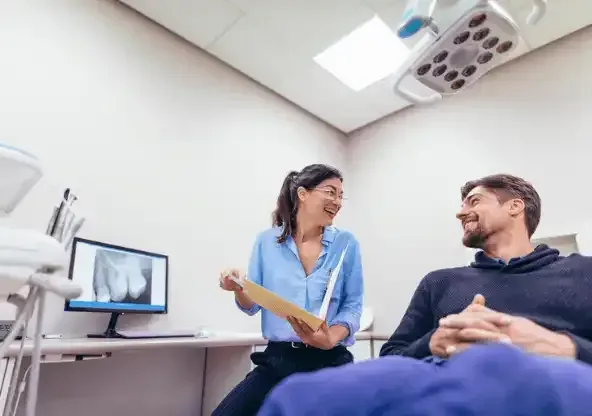 Female dentist discussing results with male patient