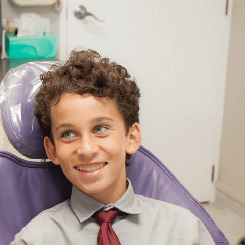 Boy smiling in dentist chair - Duxton Dental Children's Dentist