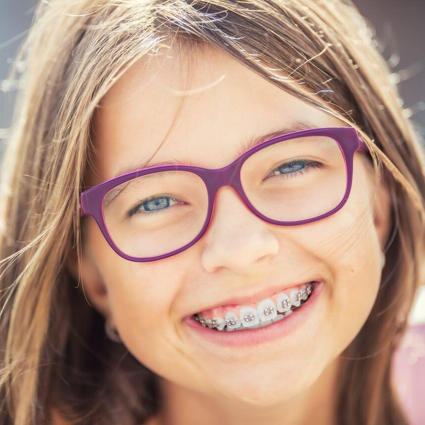 Girl smiling with braces - Duxton Dental Children's Dentist