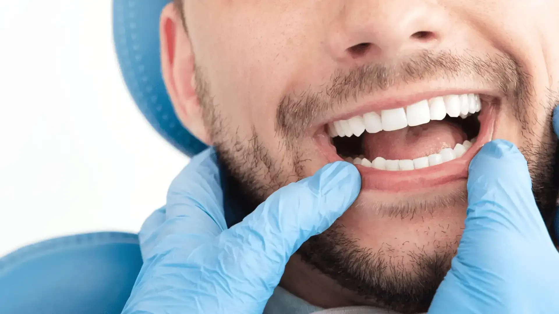 a man is getting his teeth examined by a dentist