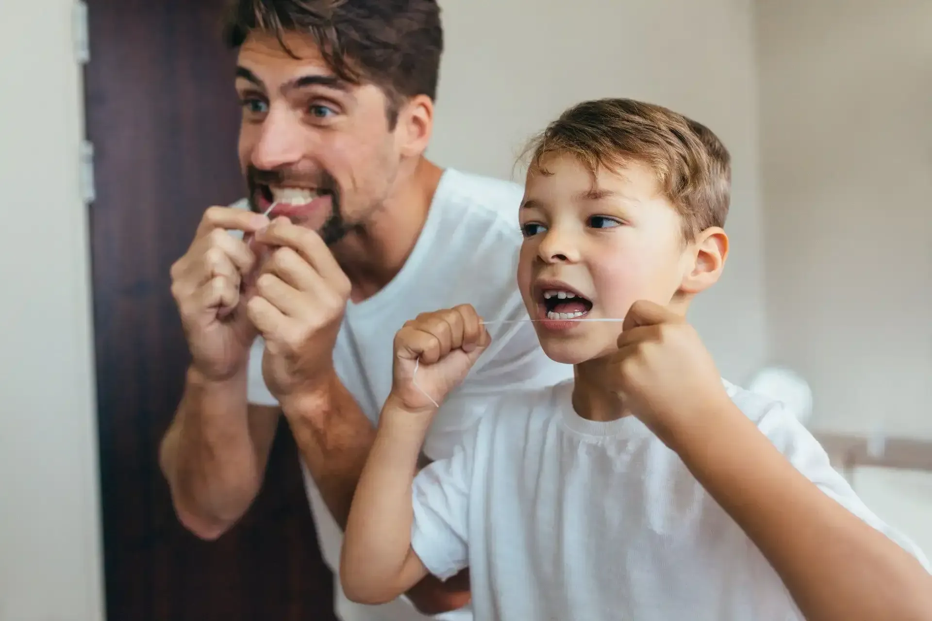 Father & Son Flossing Teeth - Duxton Dental Innovative Dentists Christchurch