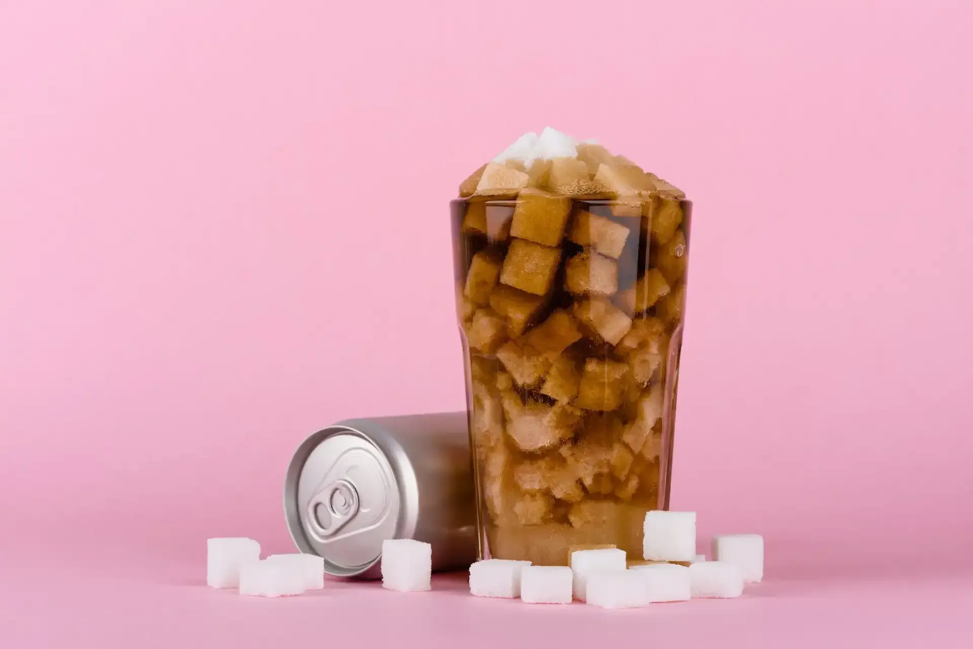 Sugary drinks - sugar cubes in a glass of coke