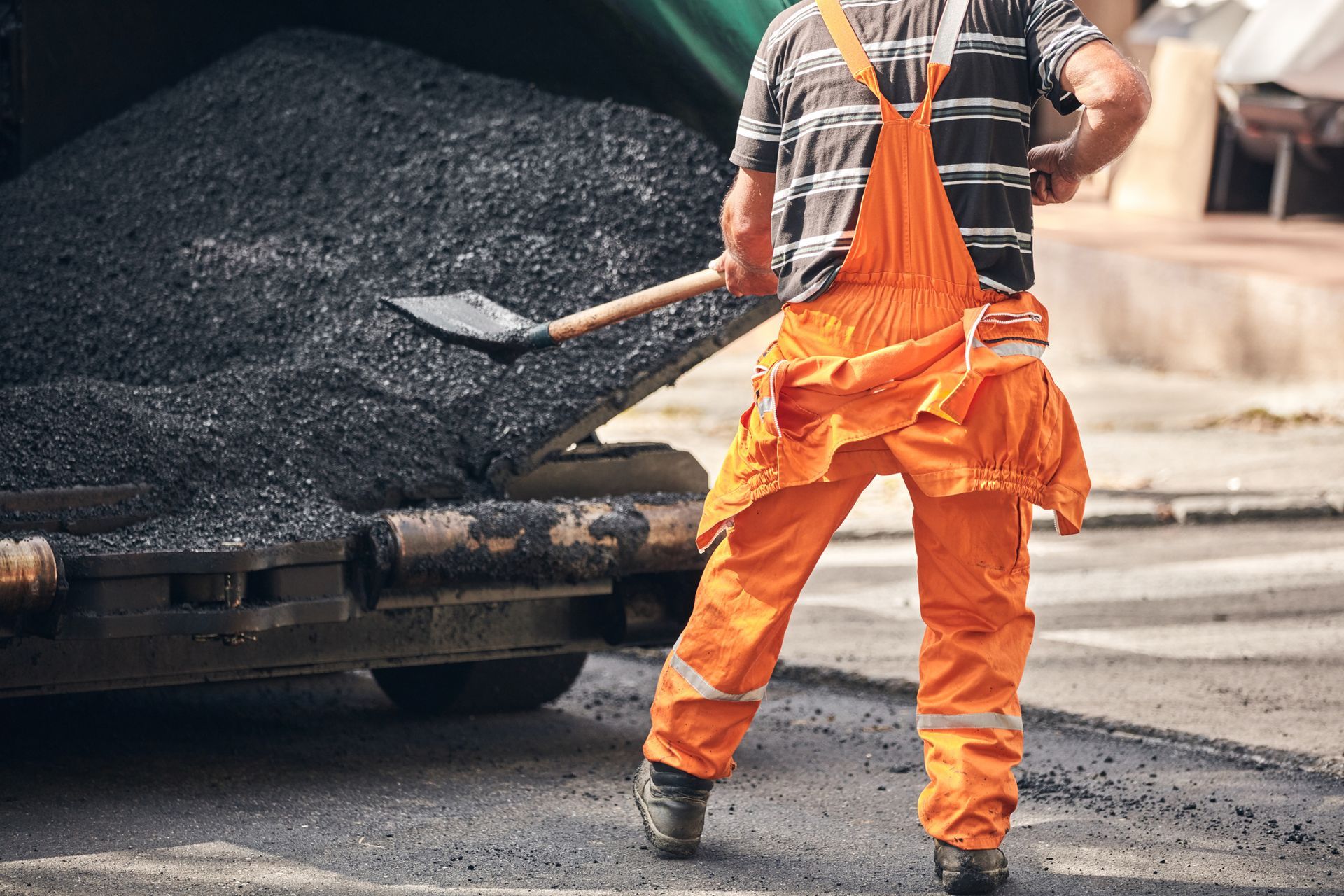 Construction workers working on a new asphalt layer on a public street. Construction workers working on a new asphalt layer on a public street.
