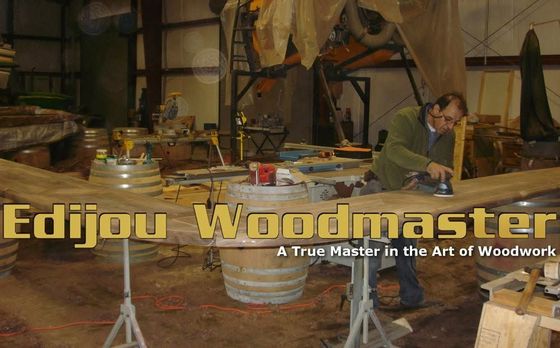 Woodworking workshop scene with tools and a man working at a bench; text reads “Edjou Woodmaster”