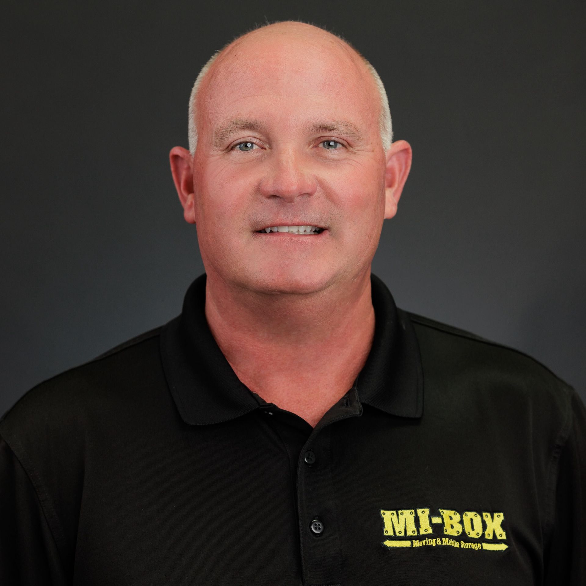 A man wearing a black shirt with the word mix-box on it