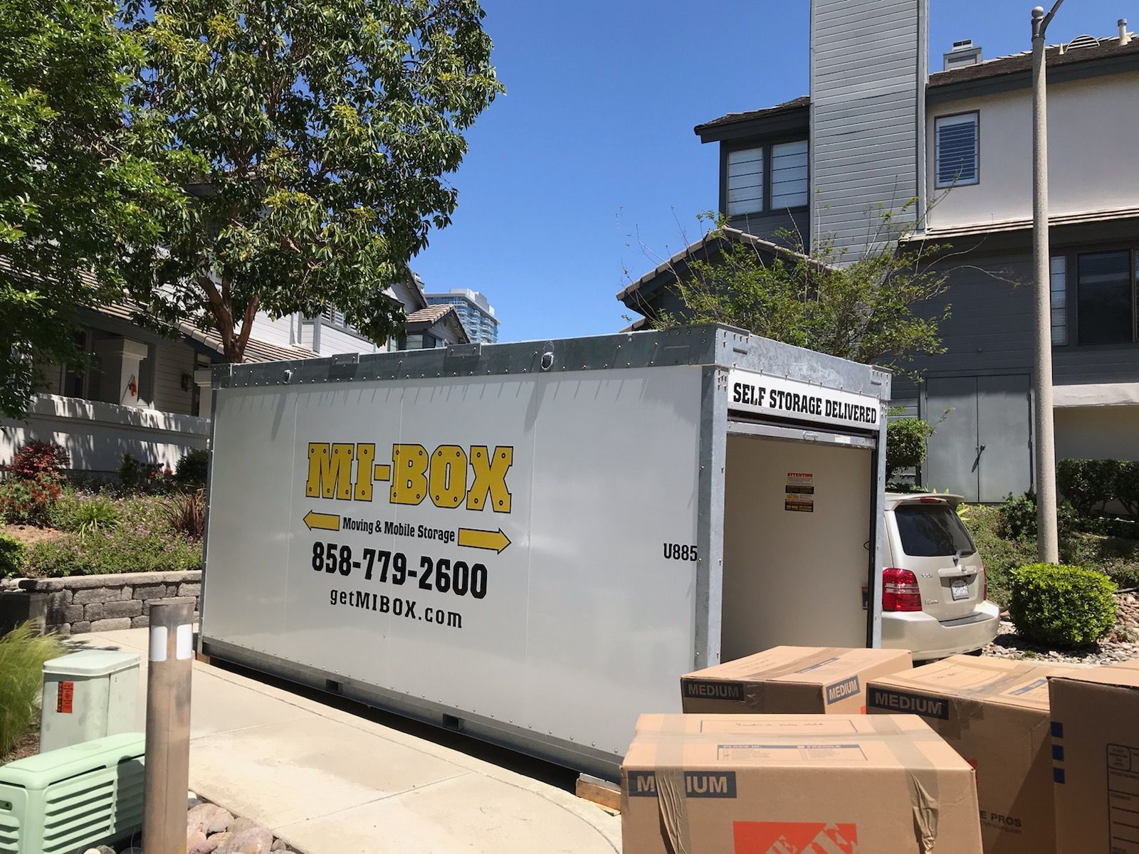 A white box truck is parked in front of a house.
