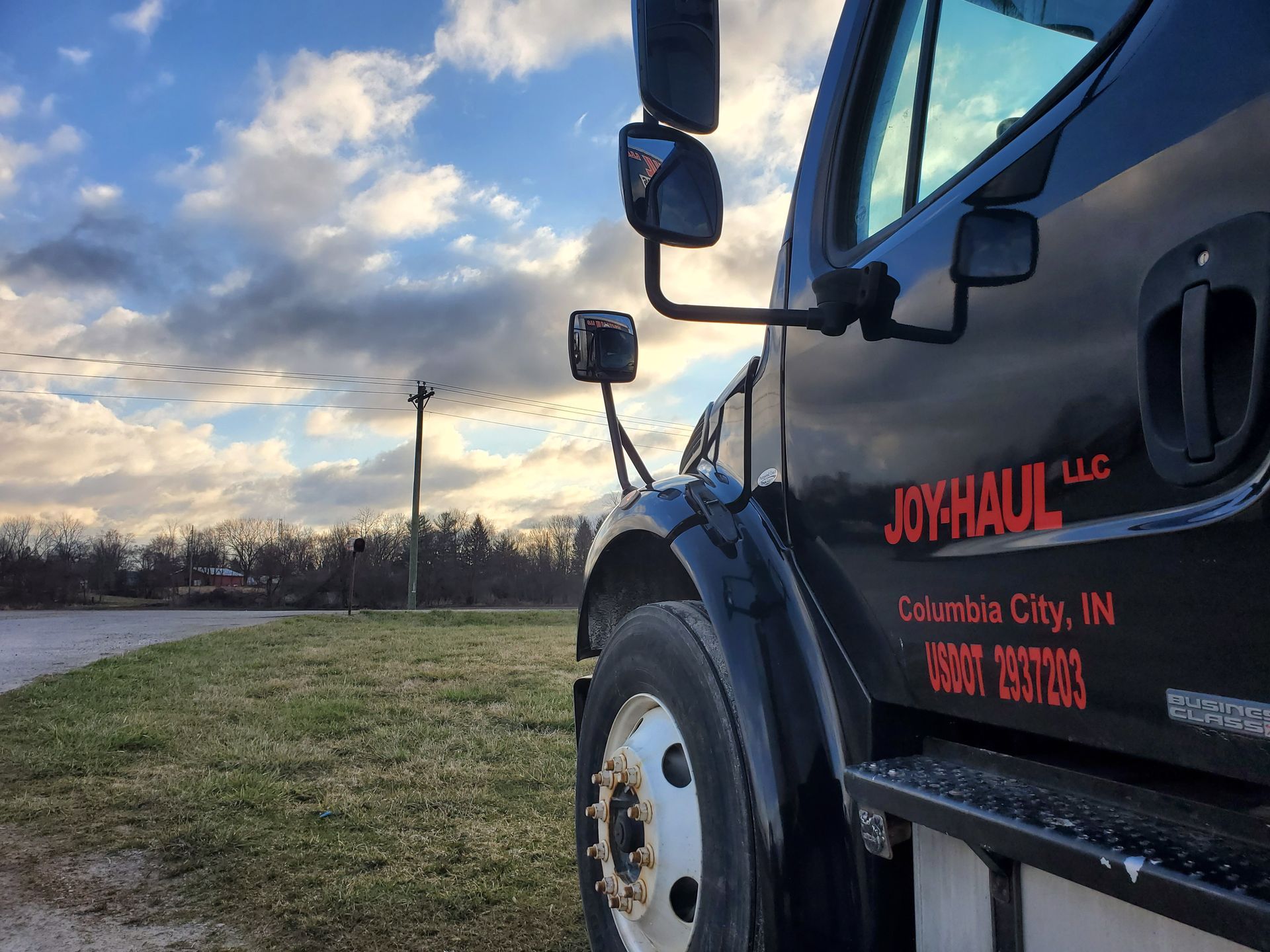 a black truck with joyhaul llc written on the side