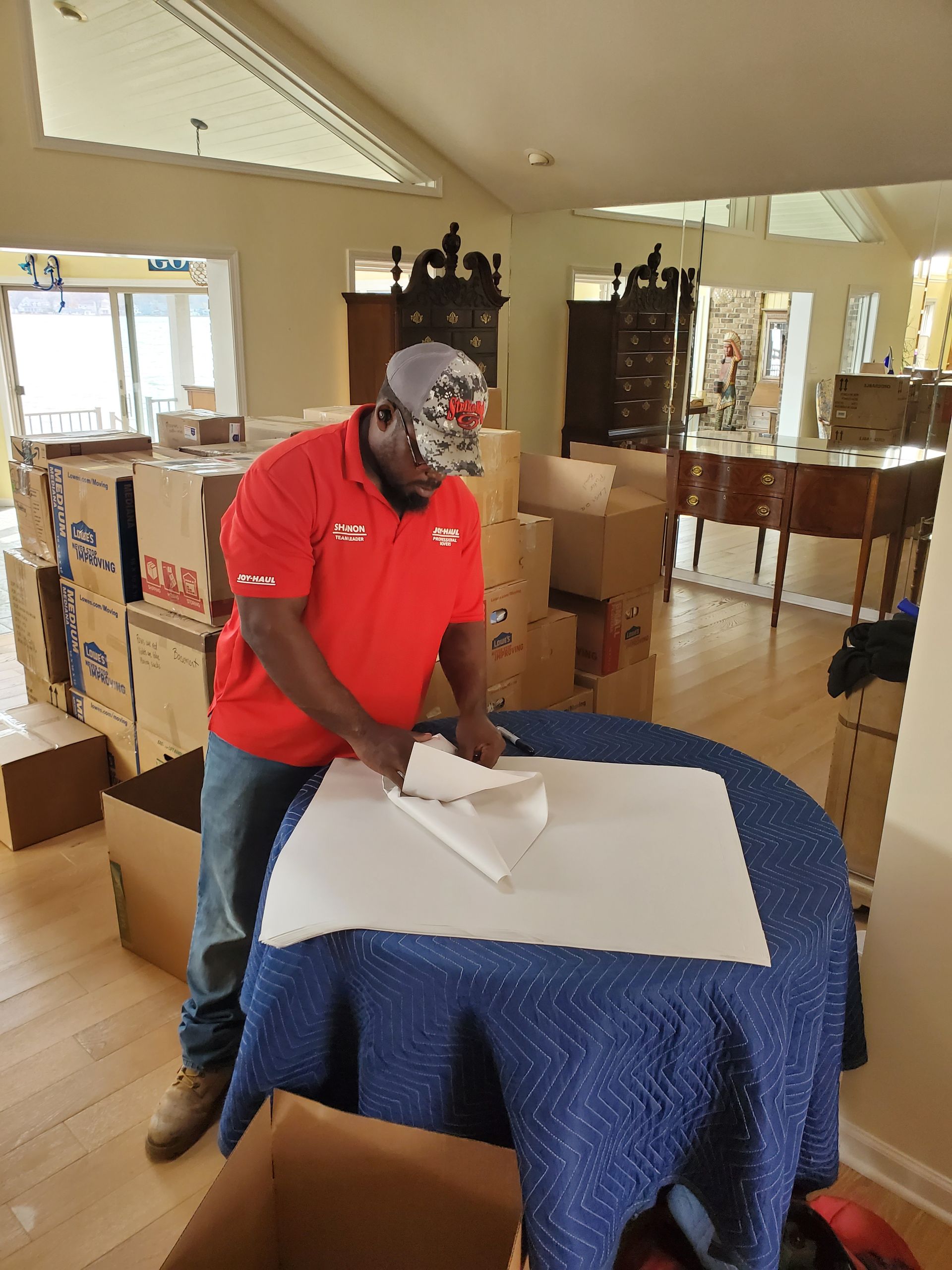 a man in a red shirt with the word moving on it