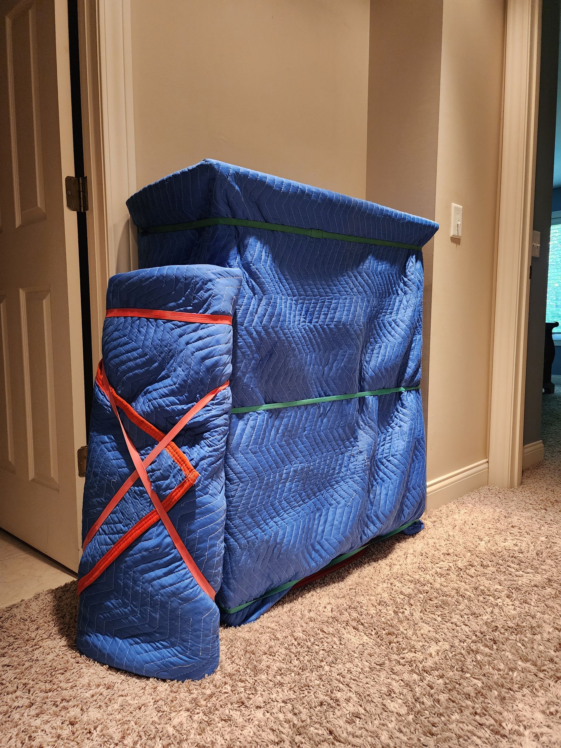 a blue blanket is wrapped around a piece of furniture in a room .