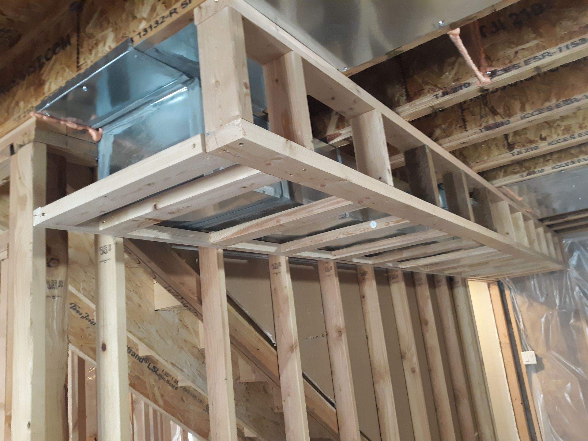 Wooden framing around ductwork in a basement stairwell.