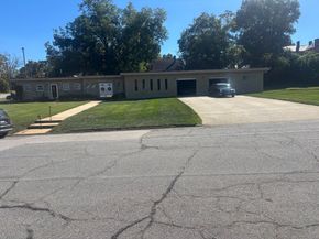 Blackwell Funeral Home with a white sign in front, building is brick.