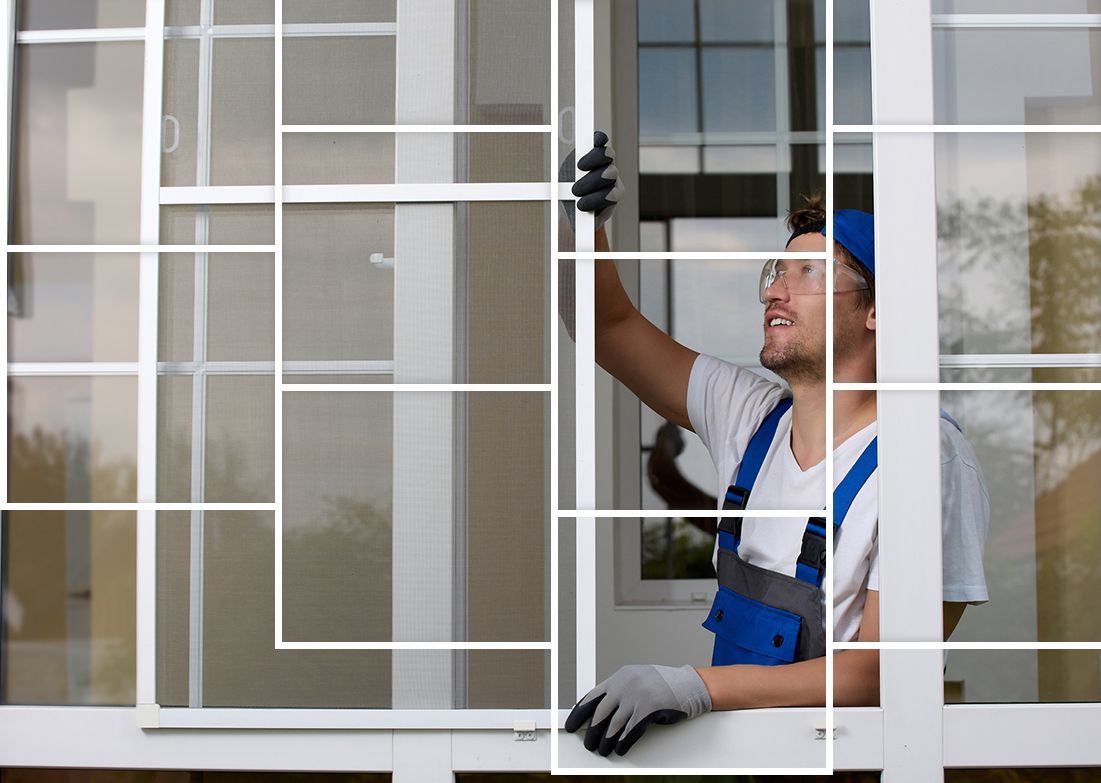A man is installing a mosquito screen on a window. A man is installing a mosquito screen on a window.