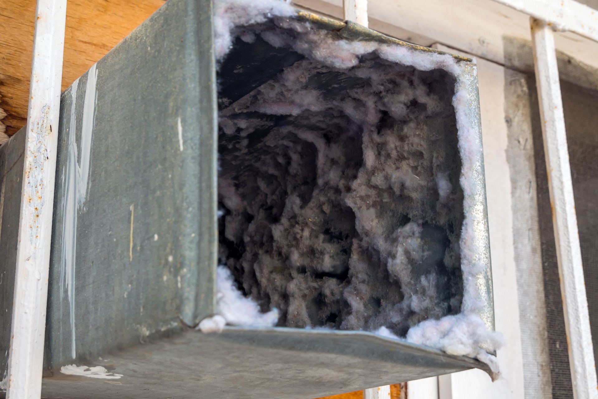 Technician inspecting dirty residential air ducts