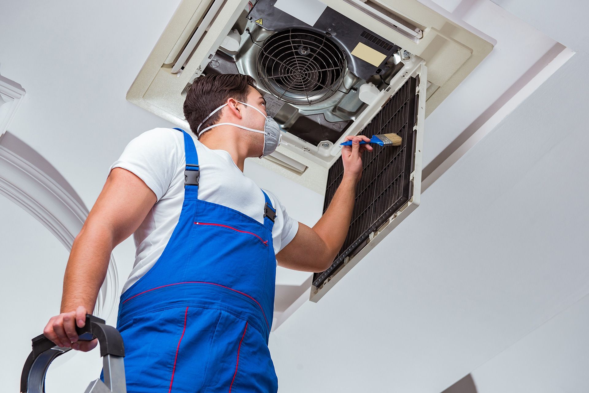 HVAC technician performing seasonal system maintenance