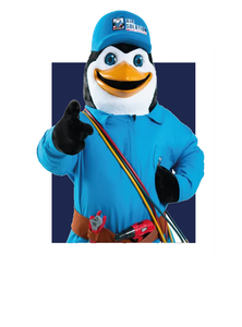 Mascot penguin in blue outfit and cap pointing at the viewer with a colorful strap across its chest