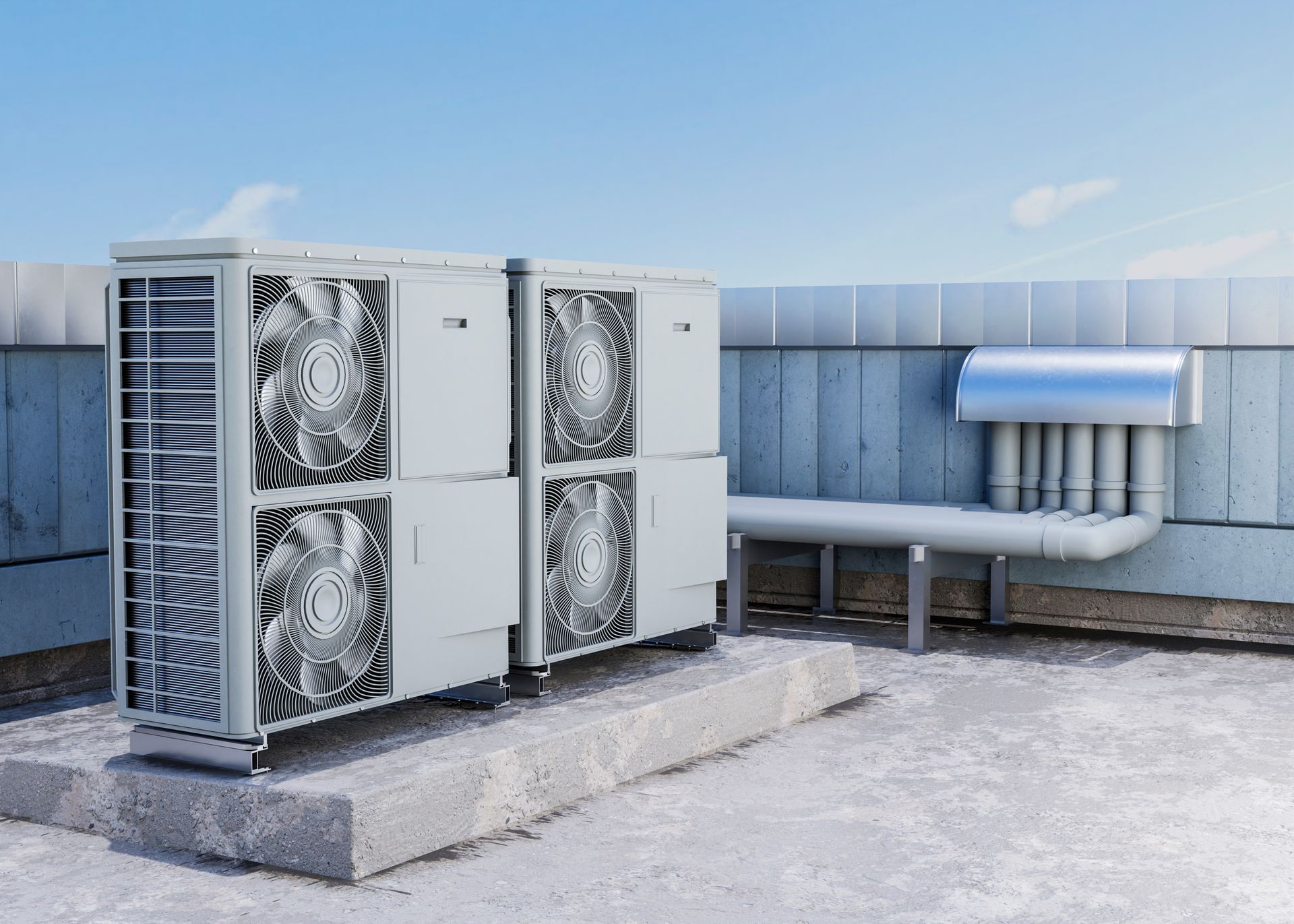 Rooftop HVAC units with large fans beside metal ductwork on a flat concrete roof.