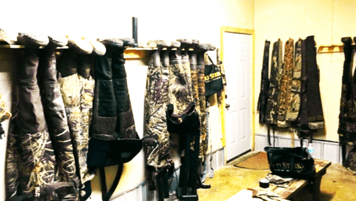 Racks of patterned coats and garments hanging in a brightly lit boutique or showroom