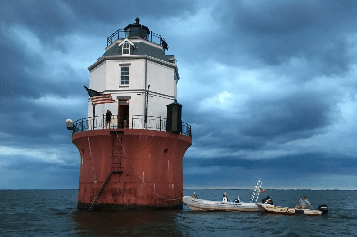 two small boats tied up to the lighthouse