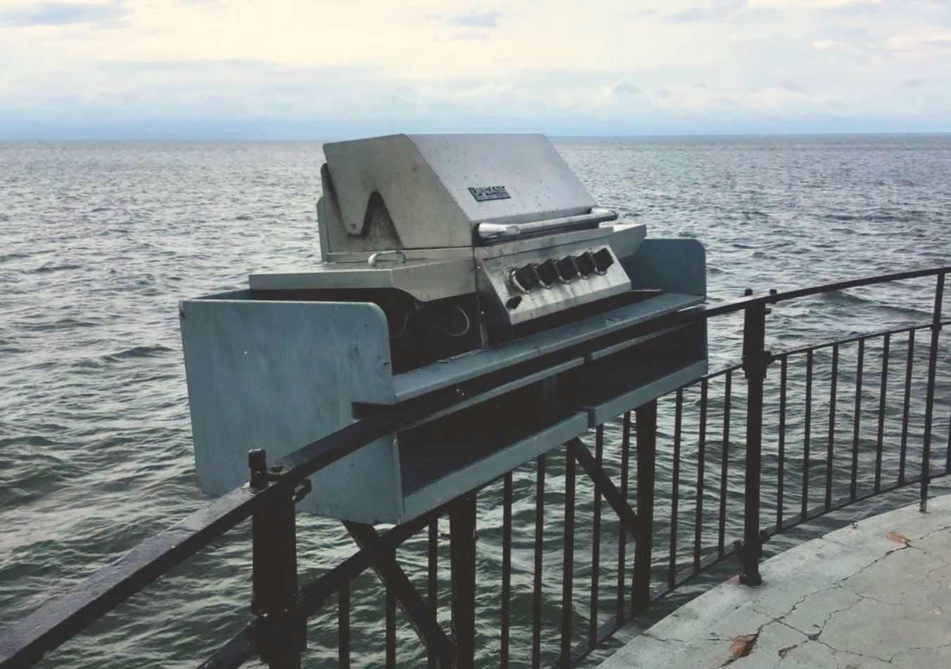 barbecue grill mounted on railing