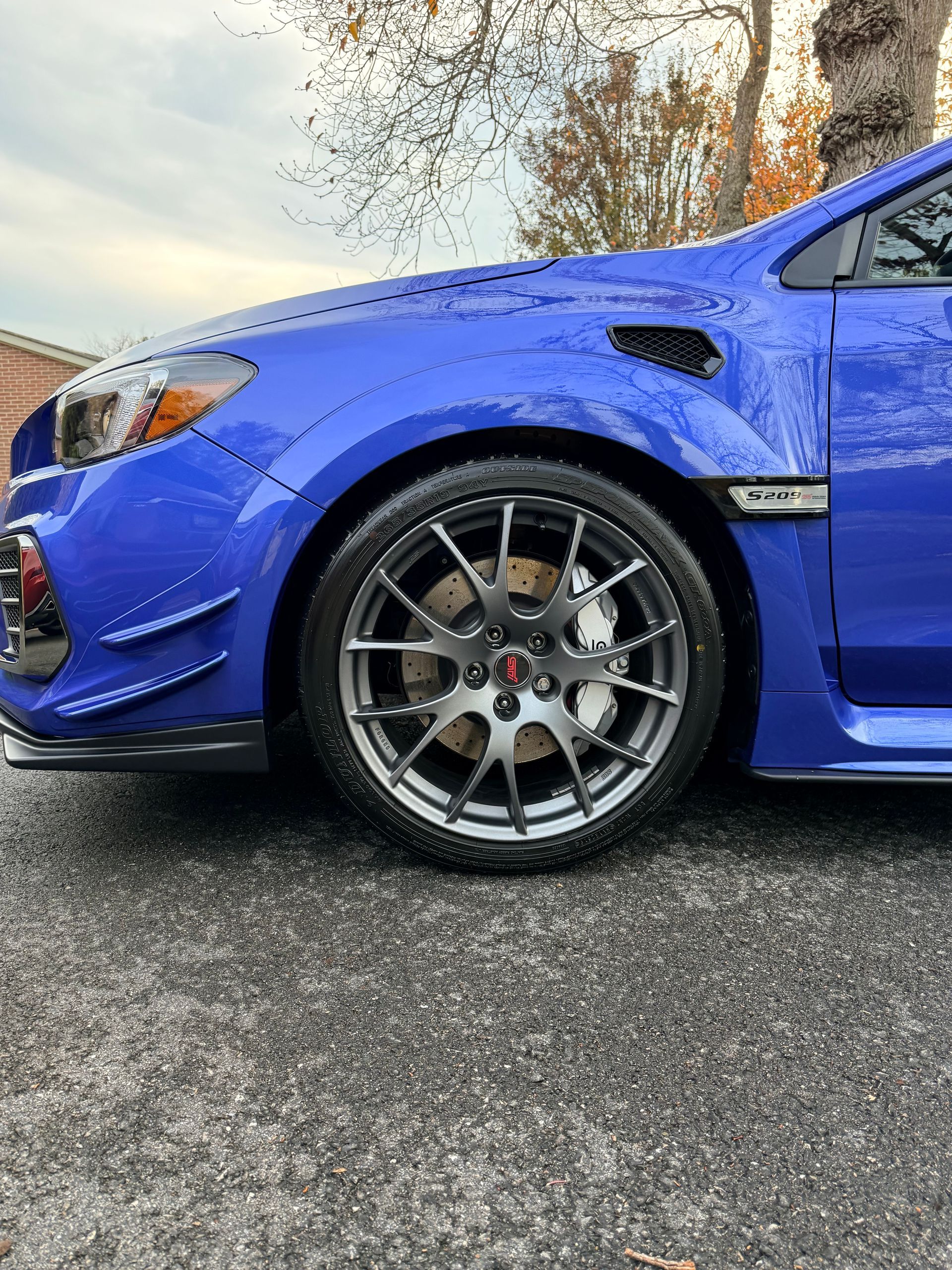 Blue sports car with clean alloy wheels and detailed exterior finish after professional mobile detai
