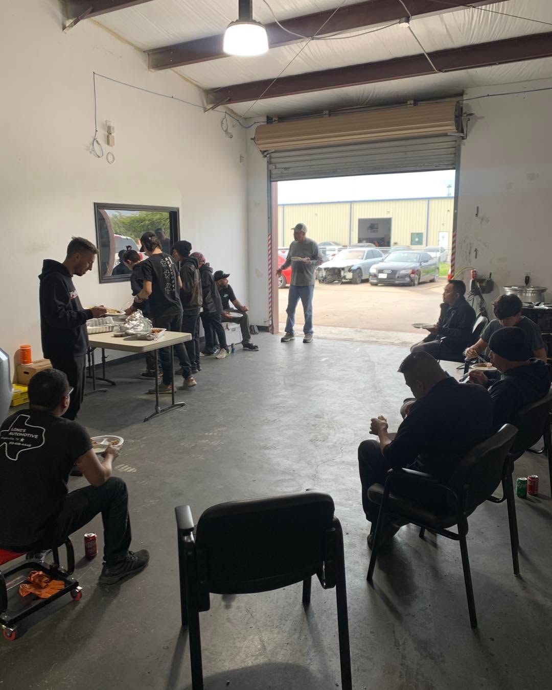 Team Gathering Inside The Auto Repair Shop | United Euro