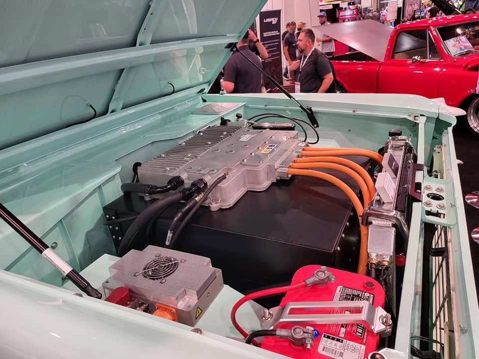 Open Engine Bay With Orange Cables And Battery Components | United Euro
