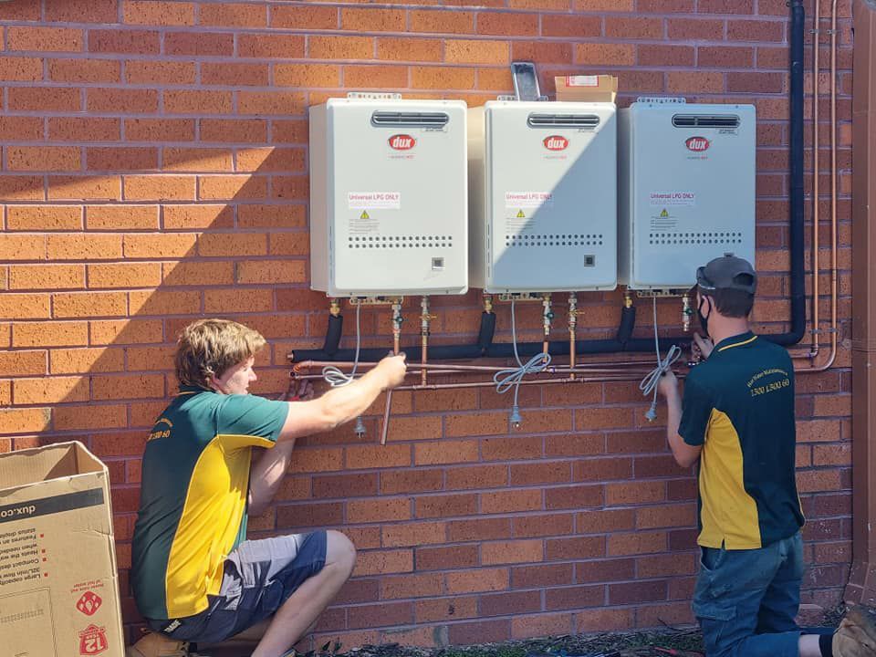 Two Technician Fixing Water Heater Boiler — Hot Water Maintenance in Port Macquarie, NSW