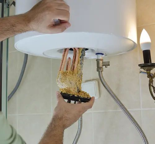 Technician Cleaning the Hot Water Tank — Hot Water Maintenance in Kempsey, NSW