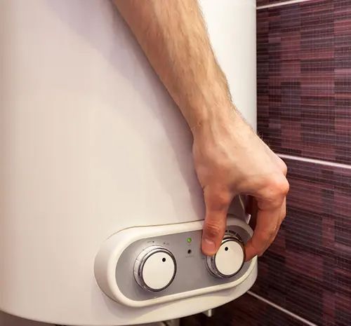 Technician Turning on The Water Heater — Hot Water Maintenance in Laurieton, NSW