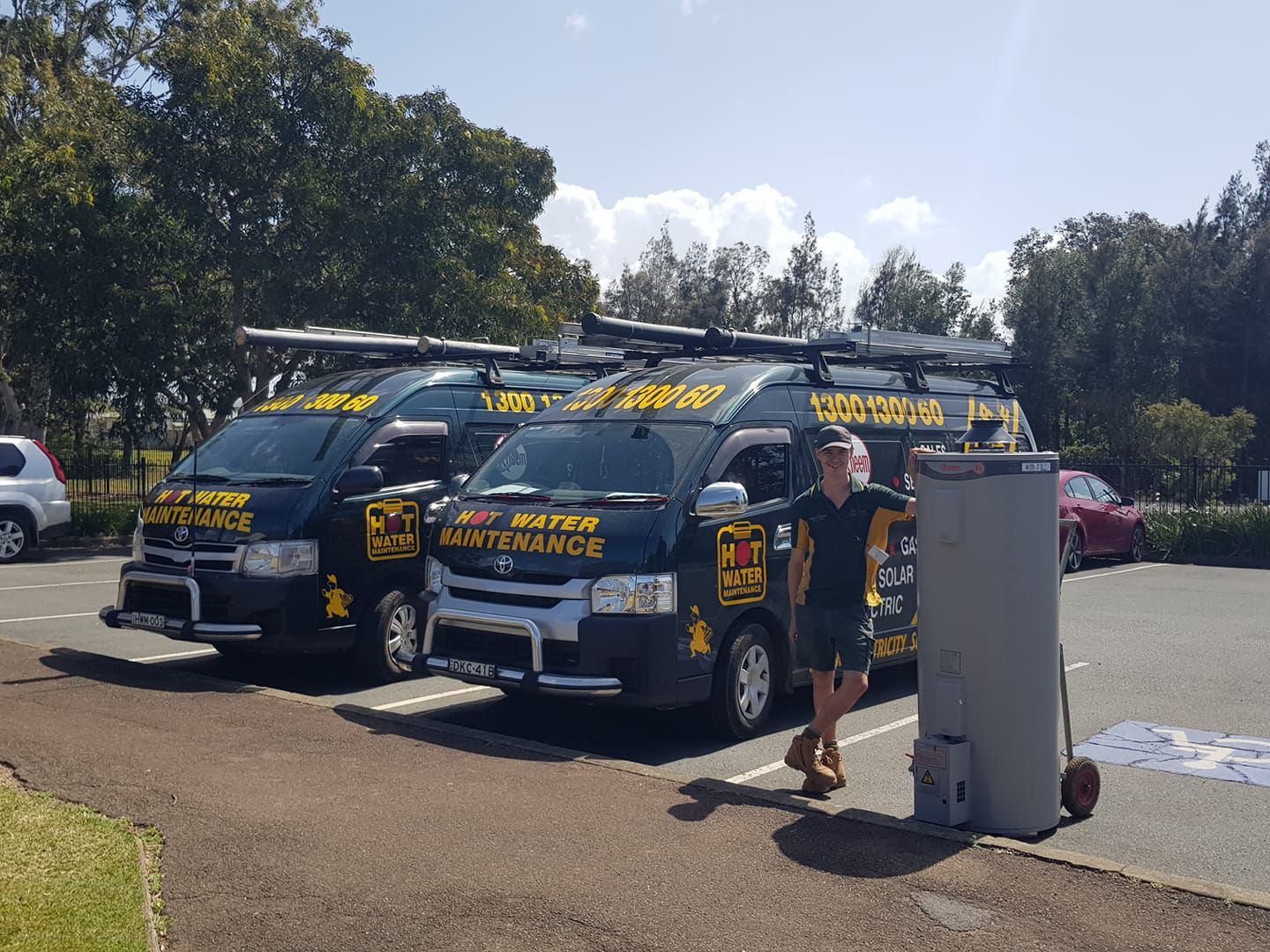 Two Business Van and Technician Holding Hot Water Tank — Hot Water Maintenance in South West Rocks, NSW