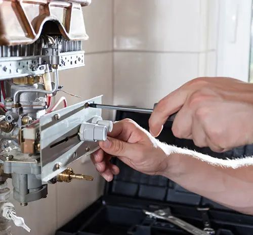 Plumber Fixing the Pipe in The Bathroom — Hot Water Maintenance in Laurieton, NSW