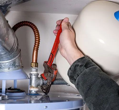 Plumber Fixing the Pipe — Hot Water Maintenance in Wauchope, NSW