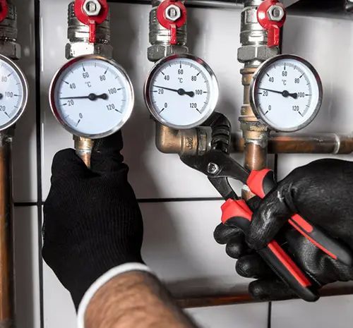 Plumber Fixing Central Heating System — Hot Water Maintenance in Laurieton, NSW