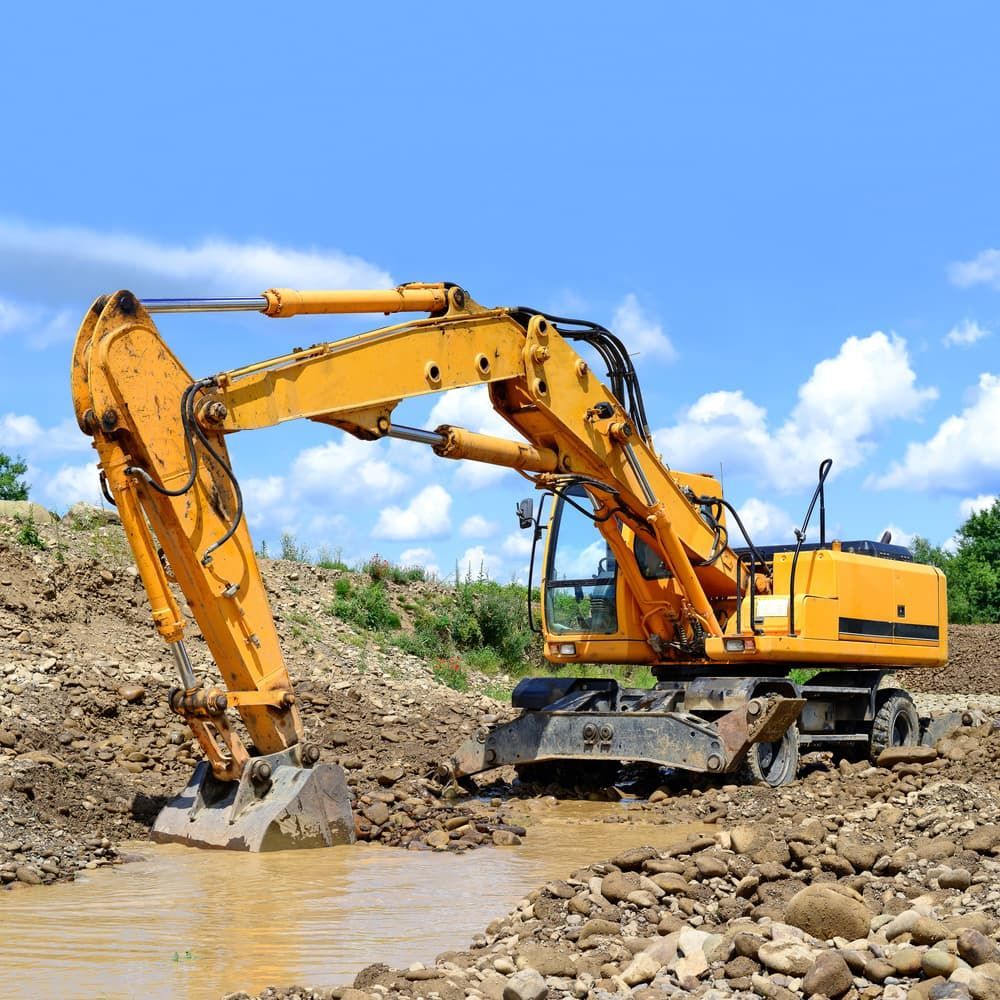 Yellow Excavator Digging in Muddy Water — Rhino Excavator & Bobcat Hire in Trinity Beach, QLD