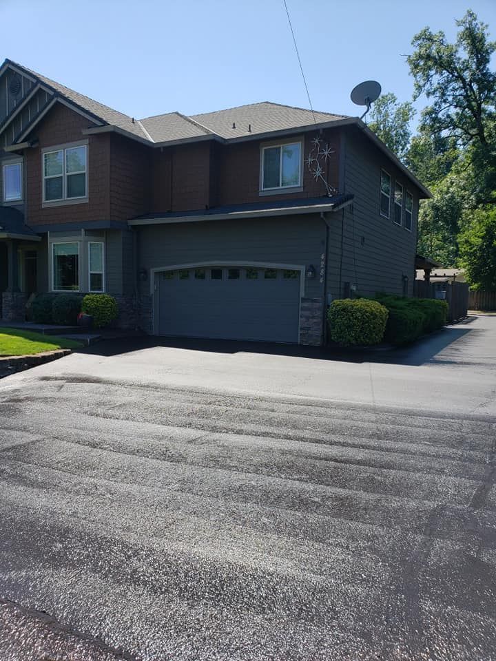 A large house with a garage and a driveway in front of it.