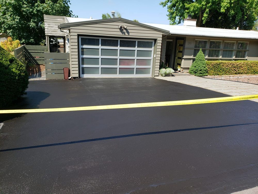 A house with a garage and a black driveway
