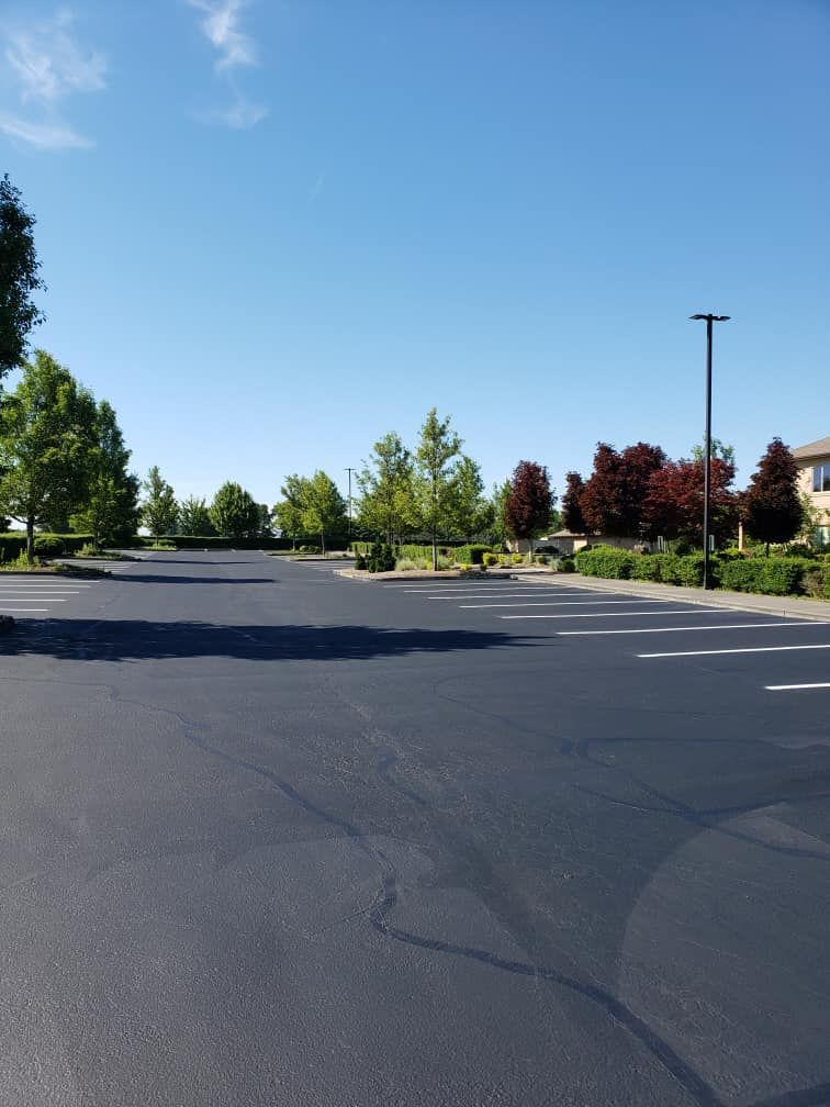 A parking lot with trees on the side of it