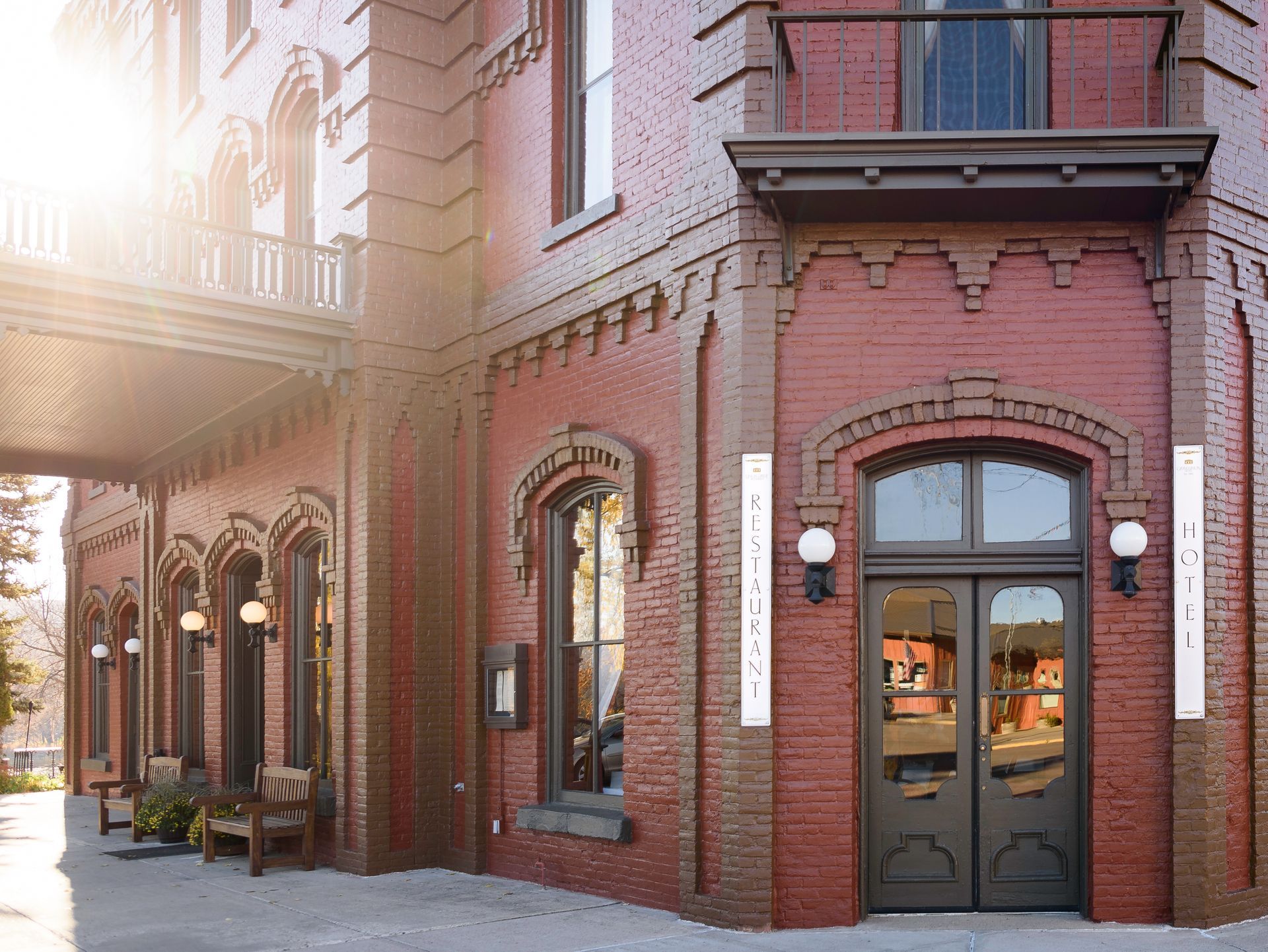 A large red brick building with a balcony and a door