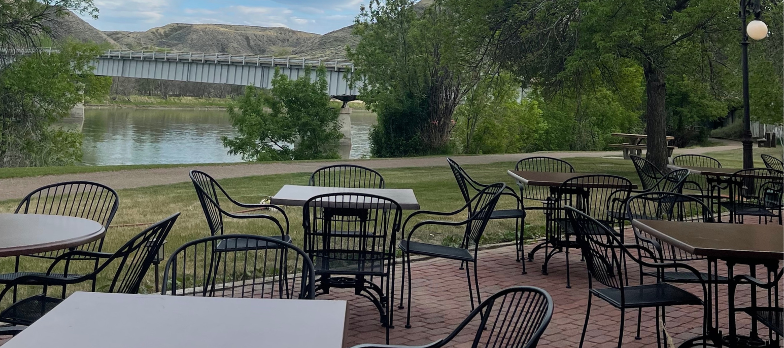 A lot of tables and chairs on a brick patio