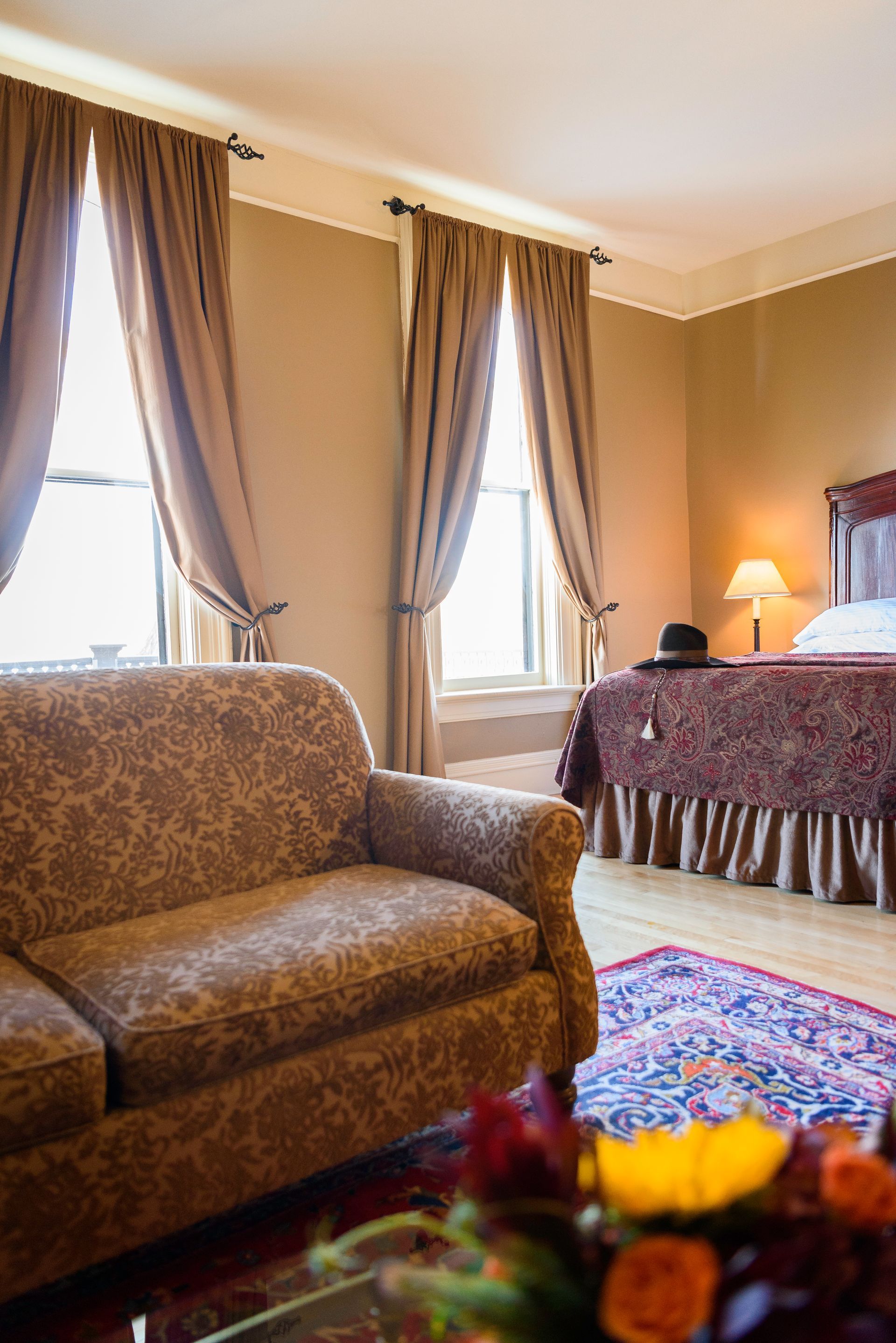 A hotel room with a couch , chair , and bed.