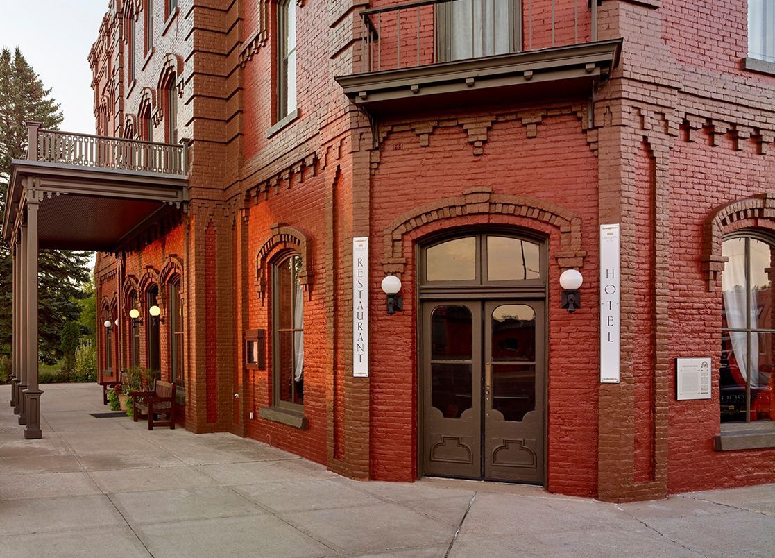A large red brick building with a balcony and a door
