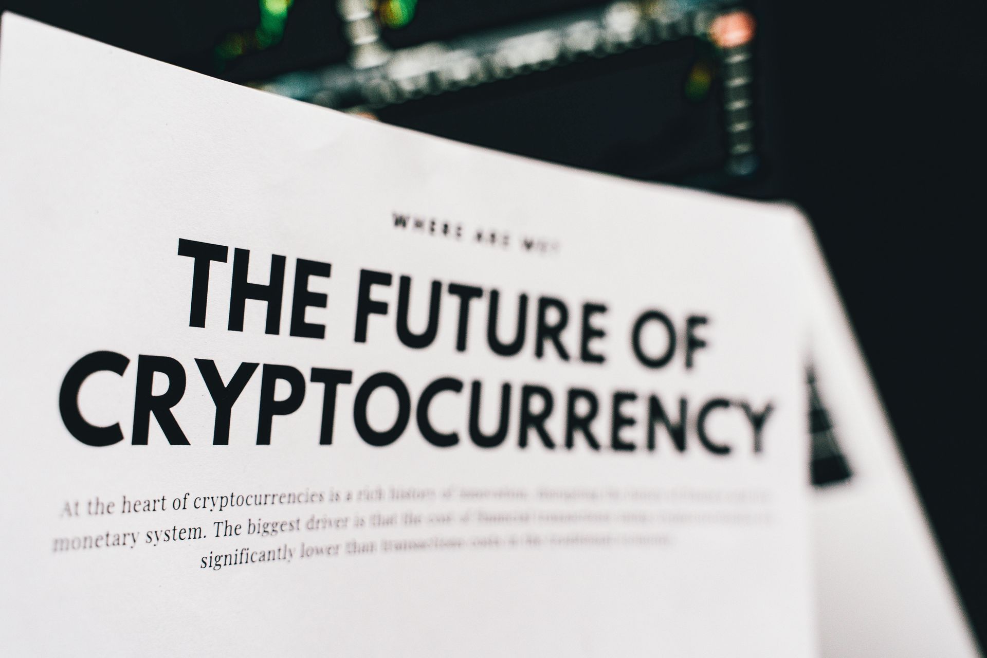 White page with bold black headline “THE FUTURE OF CRYPTOCURRENCY” on a blurred background.