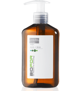 Amber pump bottle with white label and transparent dispenser cap on a white background