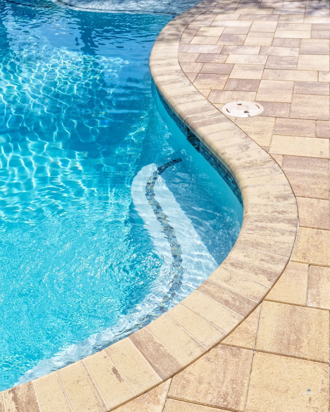 Sparkling clean water in a Southern Utah backyard pool with outdoor ground tile.