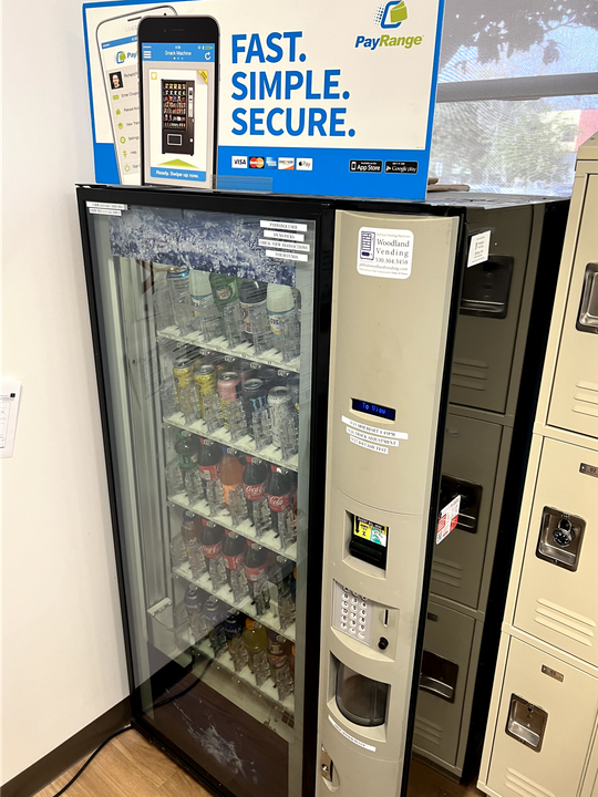 a vending machine in a room with a sign that says 