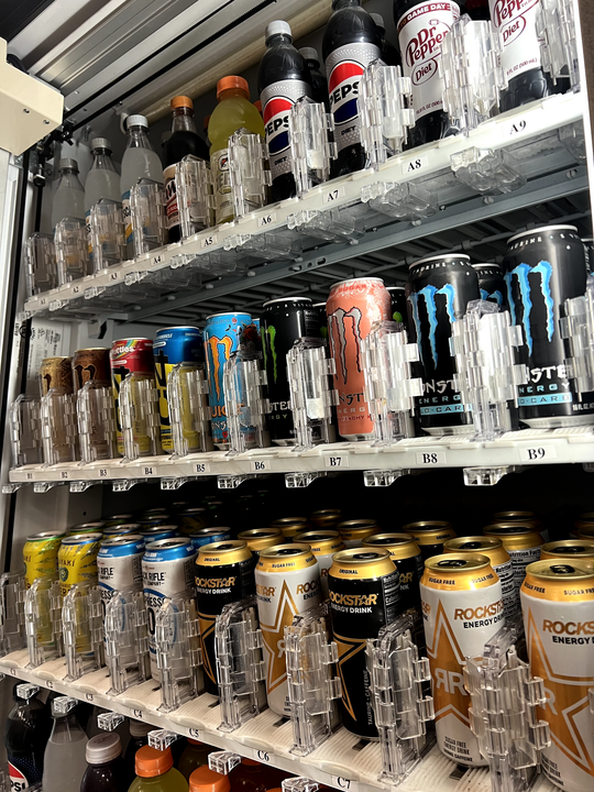 a vending machine filled with lots of cans and bottles of soda