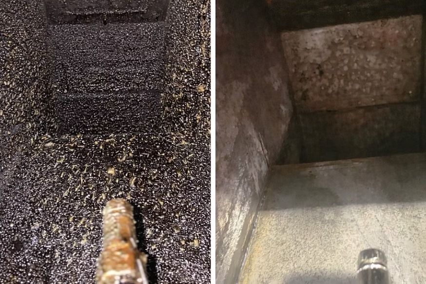 Close-up of a dark wet concrete corner with a small pipe or nozzle at the bottom