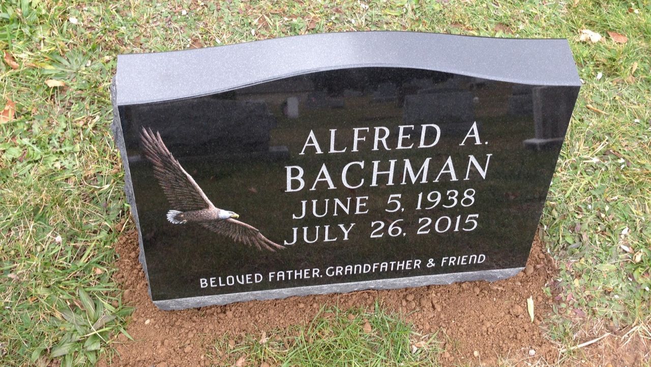 A gravestone for alfred a bachman with an eagle on it